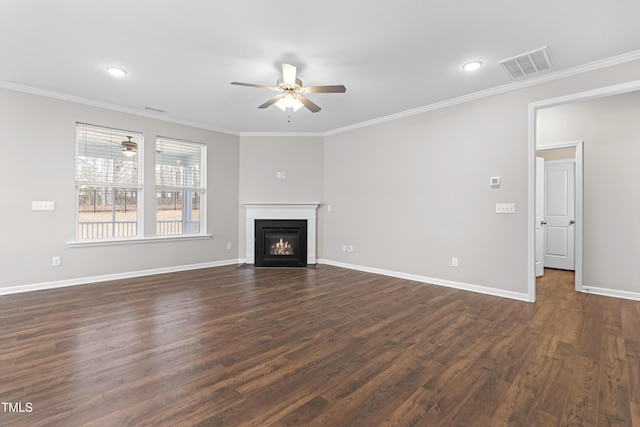 unfurnished living room featuring visible vents, dark wood-style floors, crown molding, baseboards, and ceiling fan