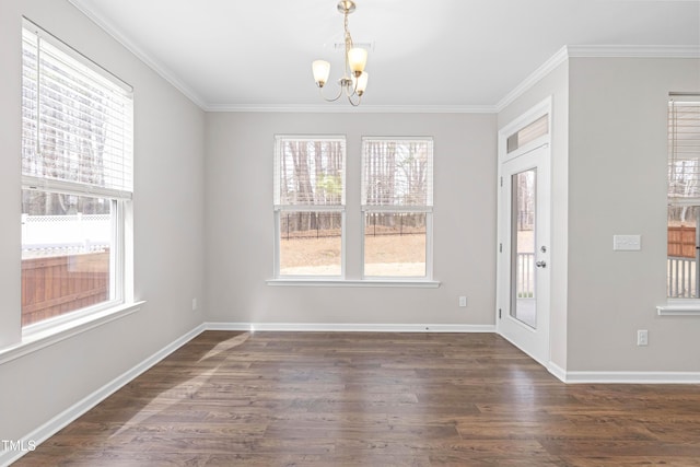 interior space with crown molding, an inviting chandelier, dark wood-style flooring, and a healthy amount of sunlight