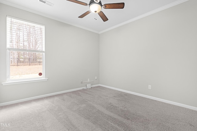 spare room featuring baseboards, visible vents, carpet floors, and ornamental molding