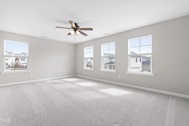 unfurnished room with carpet flooring, baseboards, and ceiling fan