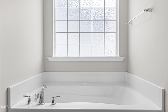 bathroom with plenty of natural light and a bath