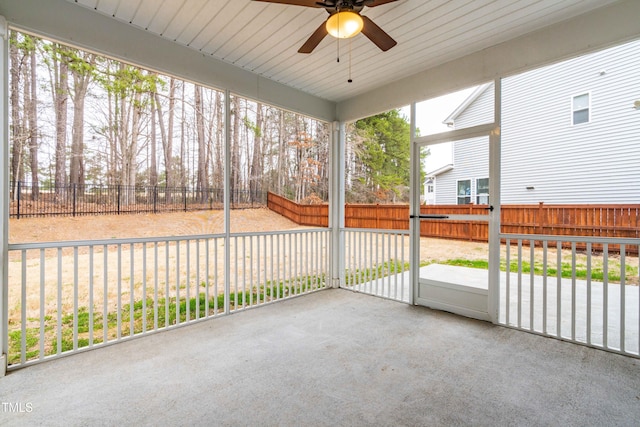 unfurnished sunroom featuring ceiling fan