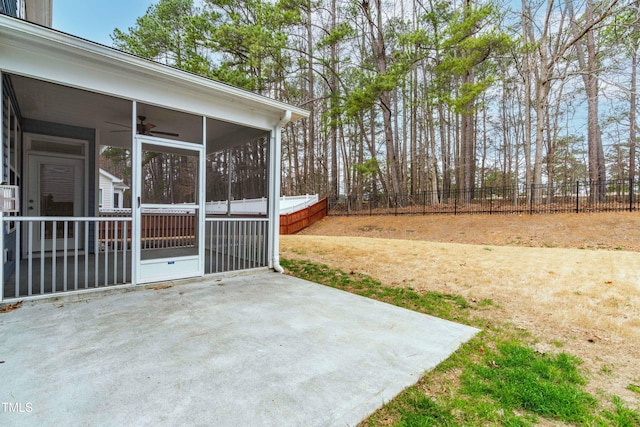 view of yard with a patio, a fenced backyard, and a sunroom