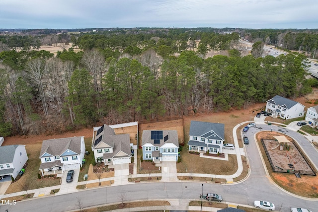 bird's eye view featuring a residential view and a wooded view