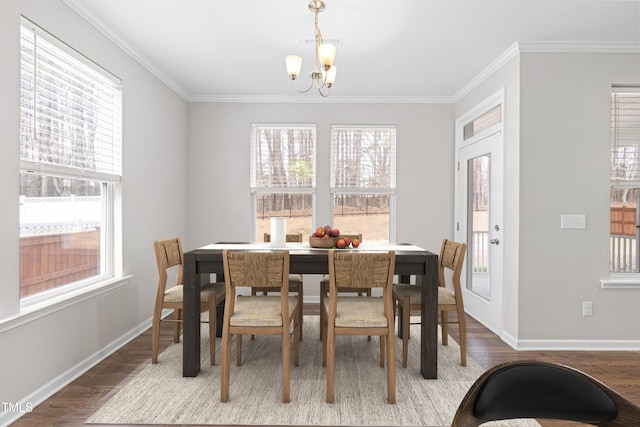 dining area with a notable chandelier, wood finished floors, and ornamental molding