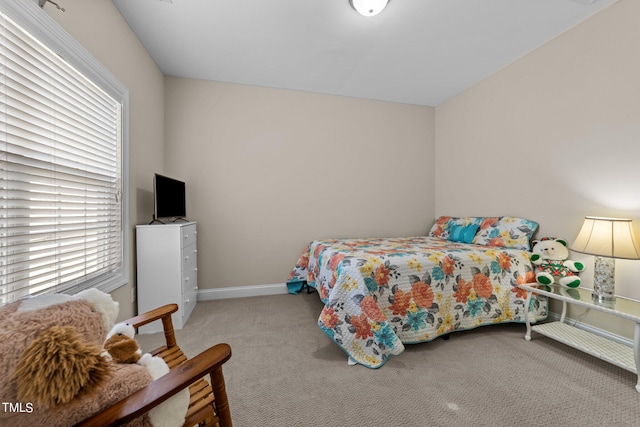 bedroom featuring carpet floors and baseboards