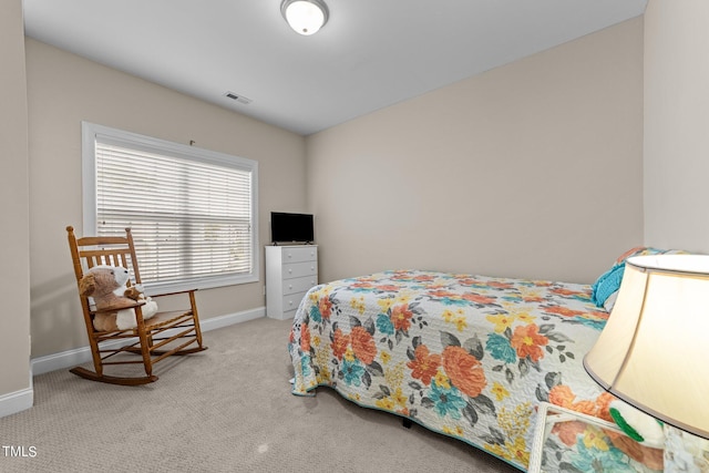 carpeted bedroom with visible vents and baseboards