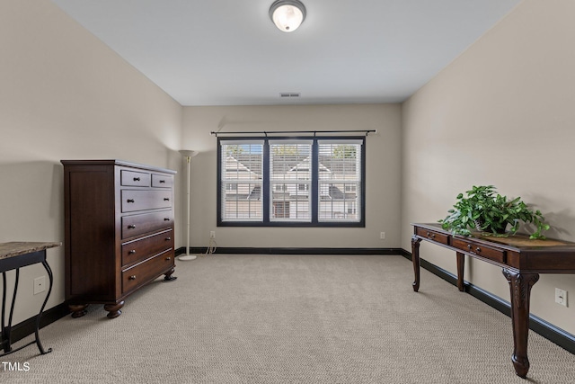 interior space featuring light carpet, visible vents, and baseboards