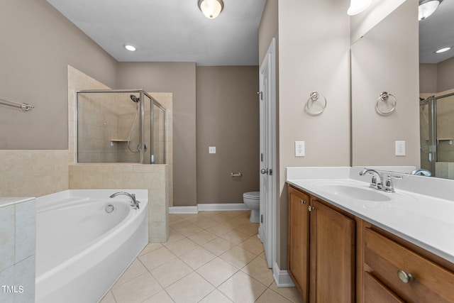 bathroom featuring a stall shower, a garden tub, vanity, and tile patterned floors