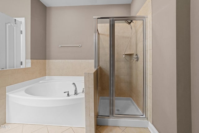 full bathroom with a garden tub, a shower stall, and tile patterned floors