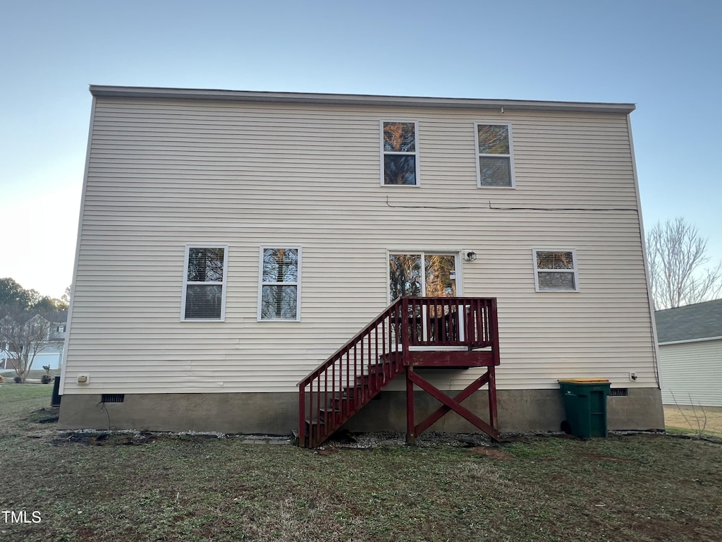 back of property featuring a lawn