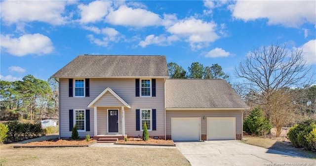 colonial home featuring an attached garage, concrete driveway, and roof with shingles