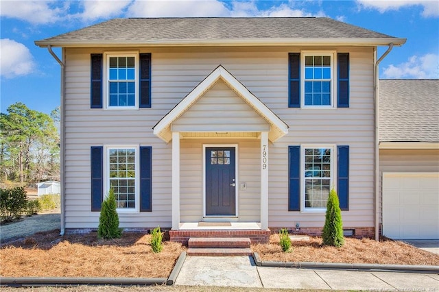 colonial home featuring a garage, driveway, crawl space, and roof with shingles