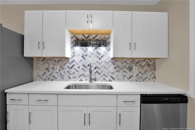 kitchen with a sink, white cabinetry, light countertops, backsplash, and dishwasher