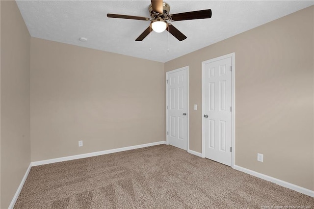 unfurnished bedroom with carpet, baseboards, and ceiling fan