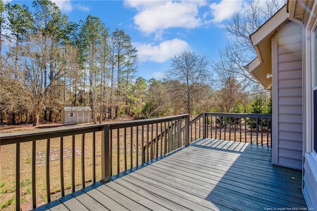 deck featuring a storage shed, a yard, and an outbuilding