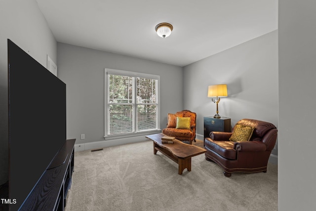 sitting room with baseboards and carpet flooring