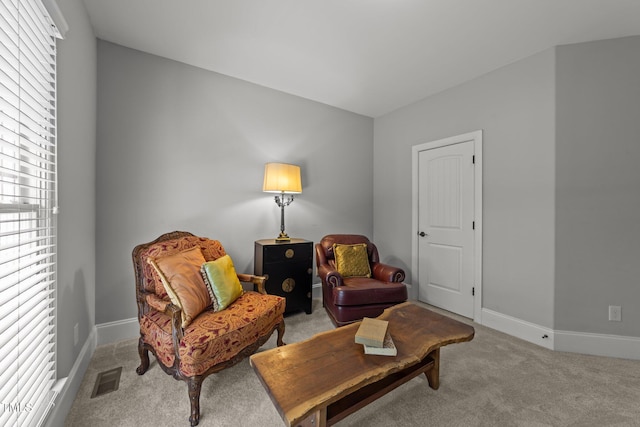 sitting room featuring carpet, visible vents, and baseboards