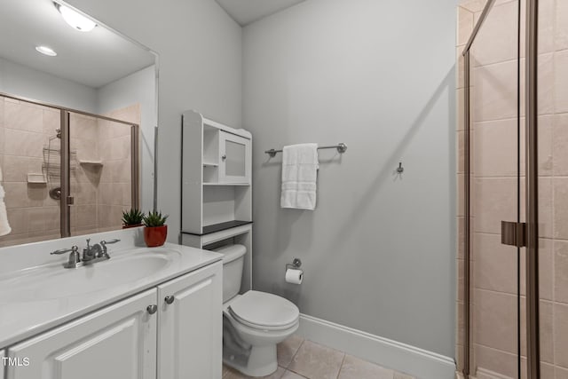 bathroom featuring toilet, a stall shower, tile patterned flooring, baseboards, and vanity