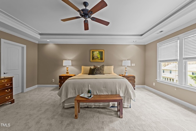 bedroom with baseboards, a raised ceiling, light colored carpet, and ornamental molding