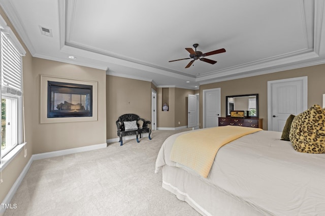 bedroom with a raised ceiling, crown molding, visible vents, and light carpet