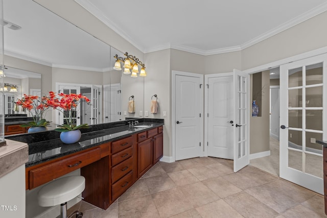 bathroom with french doors, vanity, baseboards, and ornamental molding