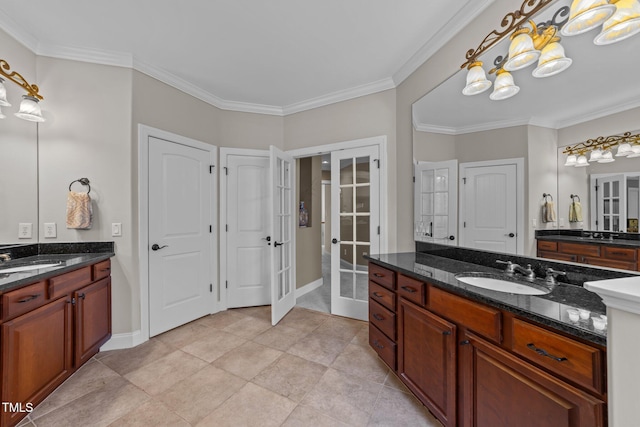 full bath featuring a sink, french doors, and crown molding