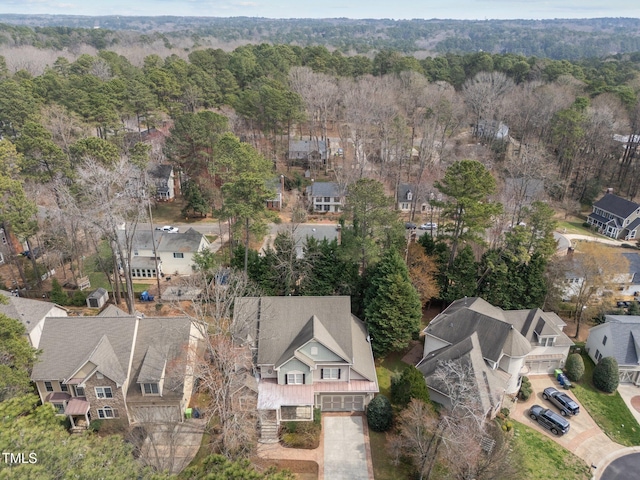 birds eye view of property featuring a residential view and a forest view