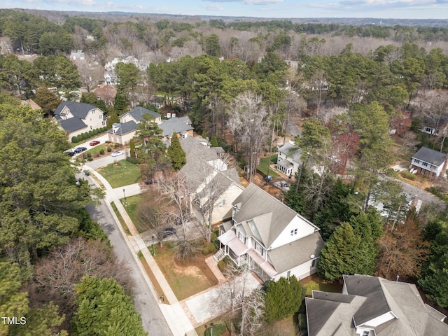 aerial view featuring a residential view and a wooded view