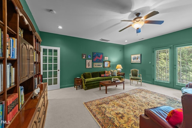 living room with carpet, baseboards, visible vents, ceiling fan, and french doors