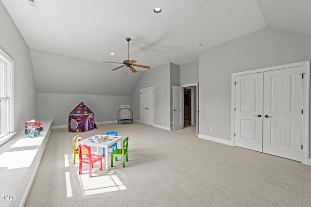 rec room featuring baseboards, lofted ceiling, and ceiling fan