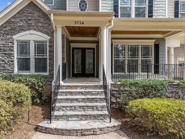 doorway to property featuring french doors and stone siding