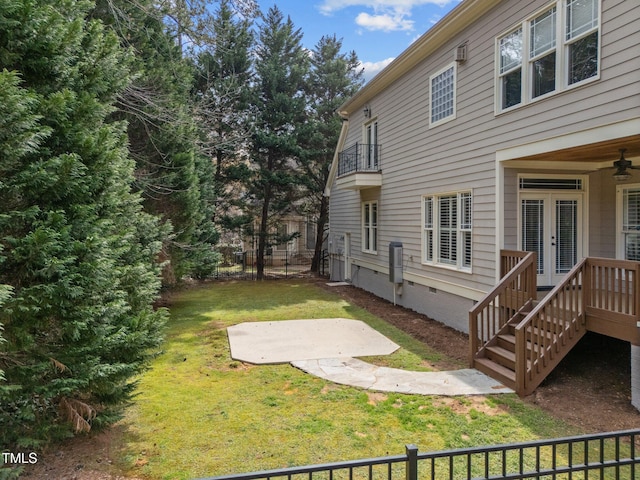 view of yard with a patio area, french doors, a balcony, and fence