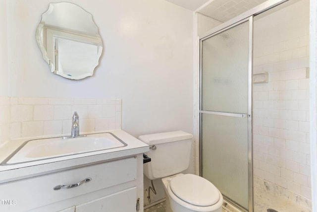 full bathroom with decorative backsplash, a stall shower, vanity, and toilet