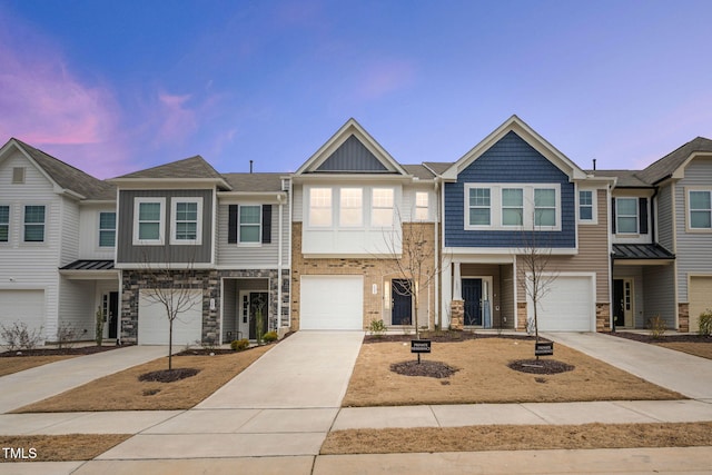 view of property featuring a garage, driveway, and board and batten siding