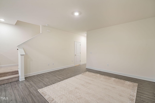 131 Wildflower Cir, Clayton, NC 27520 - unfurnished living room featuring stairs, wood finished floors, baseboards, and recessed lighting
