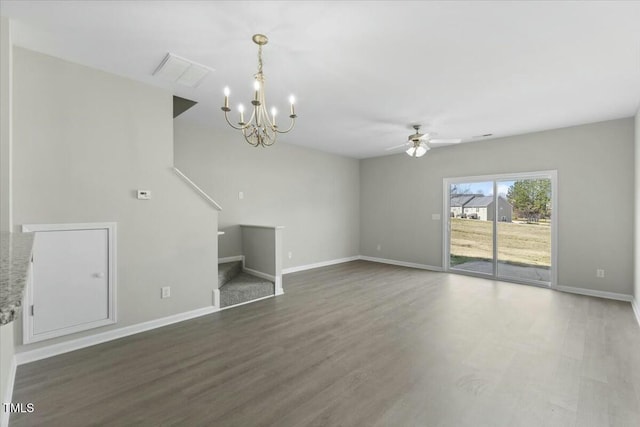 unfurnished living room featuring visible vents, baseboards, and wood finished floors