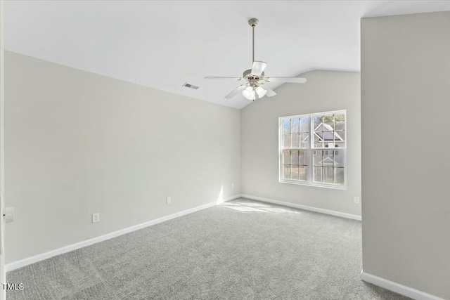 empty room with baseboards, visible vents, lofted ceiling, ceiling fan, and carpet floors