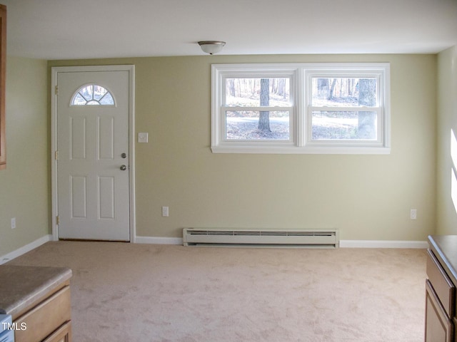 carpeted entrance foyer featuring a baseboard radiator and baseboards