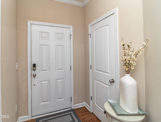 foyer entrance with dark wood finished floors and baseboards