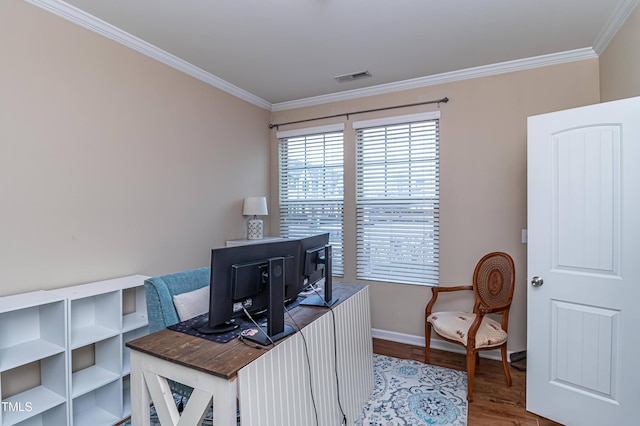 office area featuring visible vents, baseboards, wood finished floors, and crown molding