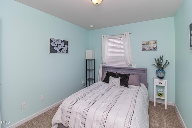 carpeted bedroom featuring baseboards