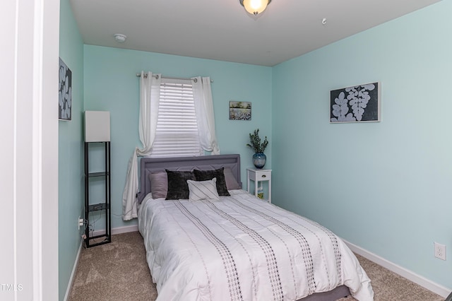 bedroom featuring baseboards and carpet