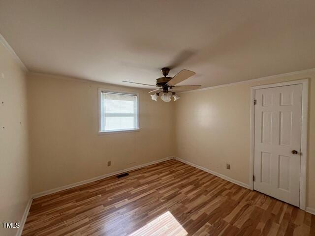 167 Chic Ennis Rd, Coats, NC 27521 - unfurnished room with baseboards, ceiling fan, crown molding, and wood finished floors