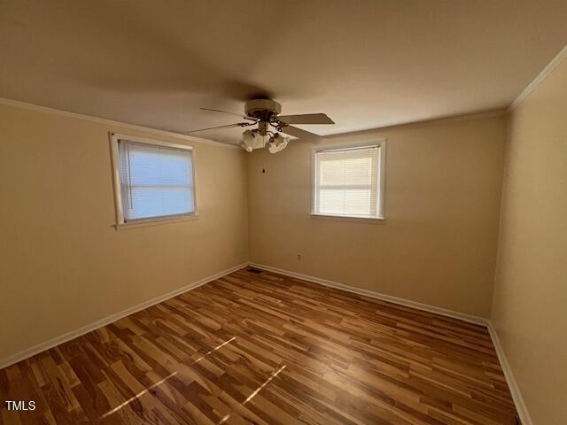 167 Chic Ennis Rd, Coats, NC 27521 - unfurnished room featuring crown molding, baseboards, a ceiling fan, and a healthy amount of sunlight