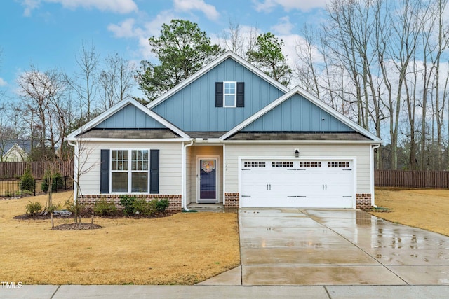 craftsman house with brick siding, fence, driveway, a front lawn, and board and batten siding