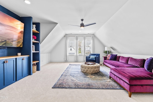 living room featuring a ceiling fan, vaulted ceiling, carpet, and baseboards