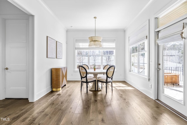 unfurnished dining area featuring hardwood / wood-style flooring, baseboards, and ornamental molding