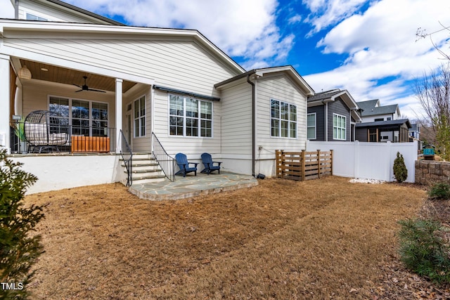 exterior space featuring a patio, a ceiling fan, and fence