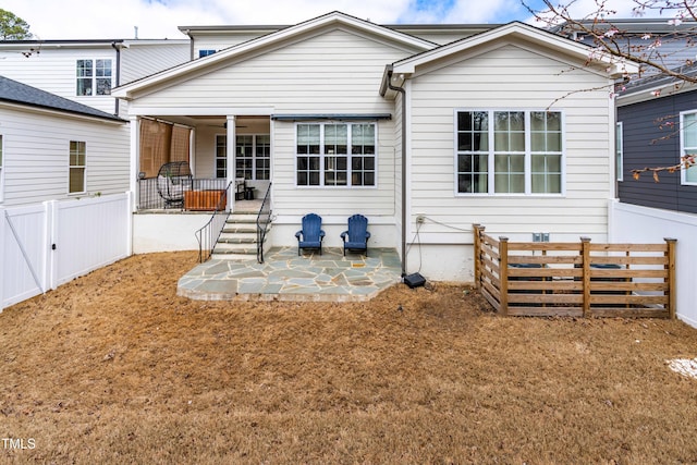 rear view of house featuring a ceiling fan, a patio, and fence